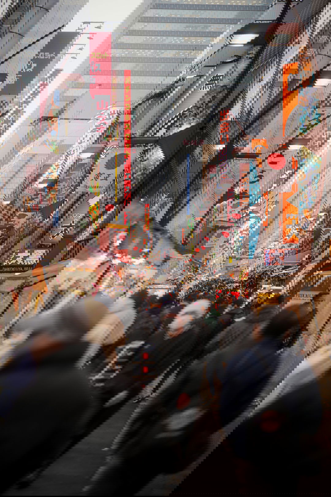 Crowded street market with japanese signs and stalls